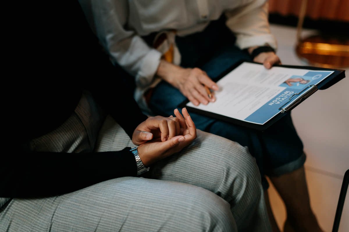 AI helps more when it organizes real information and not when it replaces your professional story. Person using digital AI tools to edit and optimize their resume on a laptop.