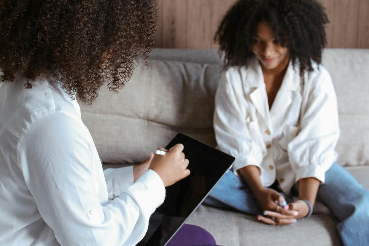Remote professional reviewing tasks at home with a structured schedule and clear workspace.